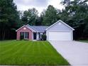 Two-toned house exterior with a driveway at 4205 Old House Dr, Conley, GA 30288