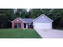 Two-toned house exterior with a driveway at 4205 Old House Dr, Conley, GA 30288