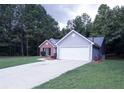 Two-toned house exterior with a driveway at 4205 Old House Dr, Conley, GA 30288