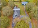 Aerial view of house, barn, and surrounding trees at 210 Pine Valley Rd, Hiram, GA 30141