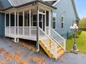 White screened porch with wooden steps and railing at 210 Pine Valley Rd, Hiram, GA 30141