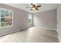 Spacious bedroom featuring wood-look vinyl flooring and large windows at 3419 River Run Trl, Decatur, GA 30034