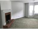 Spacious living room featuring a brick fireplace and large windows at 5632 Stonington Trace Pkwy, Stone Mountain, GA 30087