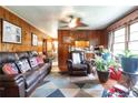 Living room with wood paneling, leather furniture, and wood floors at 3542 Lynfield Sw Dr, Atlanta, GA 30311