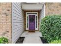 Welcoming front entry with a purple door and wreath at 5501 Somer Ridge Ct, Douglasville, GA 30134