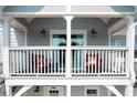 Private balcony with two red chairs and white railing at 7104 Lunker Lake Dr # 102, Douglasville, GA 30135