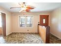 Living room with brown carpet, wooden divider, and a large ceiling fan at 225 Spring Valley Se Rd, Marietta, GA 30060