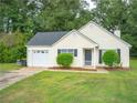 Yellow house with attached garage and large yard at 15 Marissa Cv, Riverdale, GA 30274