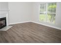 Living room with fireplace and wood-look flooring at 15 Marissa Cv, Riverdale, GA 30274