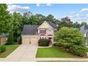 Two-story house with two-car garage and nicely landscaped yard at 209 Vine Creek Drive, Acworth, GA 30101