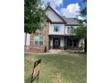 Two-story house with stone and vinyl siding, landscaping, and a large front yard at 190 Thrushwood Dr, Fayetteville, GA 30215