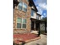 Stone and vinyl sided two-story house with a walkway and landscaping at 190 Thrushwood Dr, Fayetteville, GA 30215