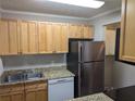 Updated kitchen features granite countertops, stainless steel appliances, and light wood cabinets at 2396 Lawrenceville Hwy # F, Decatur, GA 30033