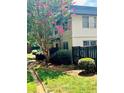 Building exterior showcasing landscaping and fence at 307 Lakemoore Ne Dr # D, Atlanta, GA 30342