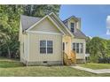 Charming yellow house with gray roof and landscaping at 2259 Sisk Nw St, Atlanta, GA 30318