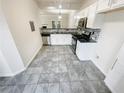 Modern kitchen with stainless steel appliances, granite countertops, and tile floors at 5319 Pinnacle Peak Ln, Norcross, GA 30071