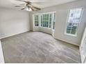Spacious bedroom with neutral carpeting, bay window, and ample natural light at 5319 Pinnacle Peak Ln, Norcross, GA 30071