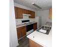 Galley kitchen with wood cabinets and white countertops at 2794 Norfair Loop, Lithonia, GA 30038