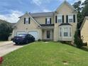 Two-story house with double garage and manicured lawn at 1080 Meadow Walk Ave, Lawrenceville, GA 30044