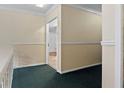 Upper hallway with carpet and door to another room at 6851 Roswell Rd # B8, Sandy Springs, GA 30328