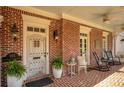 Charming front porch with rocking chairs and brick flooring at 161 Blair Valley Ne Dr, Marietta, GA 30060
