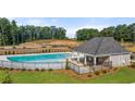 Community pool with a covered pavilion and surrounding fence at 318 Elgin Dr, Lawrenceville, GA 30045