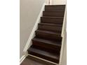 Dark brown stairs adding a touch of elegance to the home at 1189 Ashborough Se Dr # J, Marietta, GA 30067