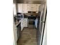 Galley kitchen with stainless steel appliances and granite countertops at 1189 Ashborough Se Dr # J, Marietta, GA 30067