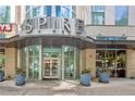 Spire building entrance with glass doors and landscaping at 860 Peachtree Ne St # 1010, Atlanta, GA 30308