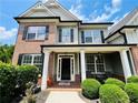 Two-story house with brick and shingle exterior, black front door at 101 Talking Leaves Ct, Acworth, GA 30101