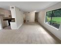 Bright living room with carpeting and view to kitchen and patio at 1472 Pine Log Ne Rd, Conyers, GA 30012