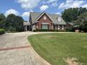 Brick home with a large lawn at 265 Regal Dr, Lawrenceville, GA 30046