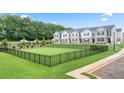 Community dog park with black metal fencing and green grass at 348 Elgin Dr # 162, Lawrenceville, GA 30045