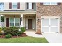 Front entrance with stone accents, a double door, and a covered porch at 2732 Warm Season Sw Dr, Powder Springs, GA 30127