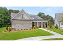 Craftsman style home with brick facade, metal roof, and two-car garage at 3739 Tielman St, Snellville, GA 30078