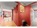Light wood floors and coral walls in a condo hallway at 3435 Kingsboro Ne Rd # 1201, Atlanta, GA 30326