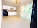 Kitchen with white cabinets, black appliances, and granite countertops at 6626 Dorian Dr, Union City, GA 30291