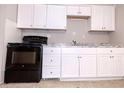 White cabinets and black appliances in this galley style kitchen at 6626 Dorian Dr, Union City, GA 30291