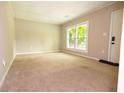 Bright and airy living room with neutral carpet and large windows at 6626 Dorian Dr, Union City, GA 30291