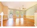 Living room with light wood laminate flooring and neutral walls at 3302 Mixon Way, Stone Mountain, GA 30087