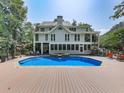 Inviting swimming pool with a deck and screened porch at 1012 Jubilee Way, Powder Springs, GA 30127