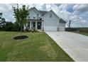 Two story home with white siding, three car garage, and front porch at 37 Ridgeline Nw Way, Cartersville, GA 30121