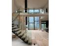Modern floating staircase with glass and wood accents at 2147 Briarwillow Ne Dr, Atlanta, GA 30345