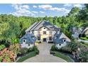 Luxury estate home with expansive driveway and mature trees at 4317 Oglethorpe Nw Loop, Acworth, GA 30101