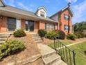 Brick townhouses with a shared walkway and landscaping at 3266 Henderson Mill Rd # C, Atlanta, GA 30341