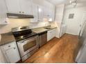 Galley kitchen with stainless steel appliances and wood floors at 3266 Henderson Mill Rd # C, Atlanta, GA 30341