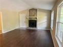 Bright living room with fireplace and hardwood floors at 7508 Asbury Manor Dr, Lithonia, GA 30058