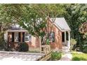 Brick ranch house with a small porch and landscaping at 1054 Plantation Nw Way, Kennesaw, GA 30144