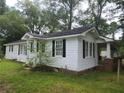 White house with black shutters and a brick foundation at 5015 Suwanee Dam Rd, Suwanee, GA 30024