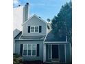 Gray siding, black shutters, and a charming front entrance at 603 Brighton Ct, Norcross, GA 30071